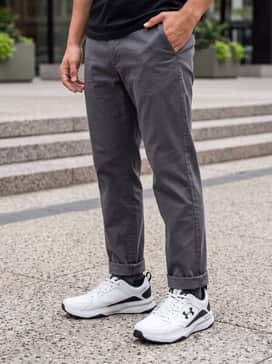 Slim-fit medium wash jeans, a crisp white heavy-cotton crewneck sweater, and a black puffer vest for a clean, casual weekend look.