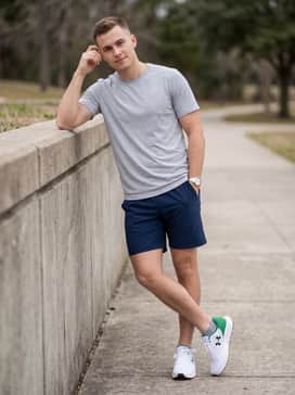 Ua Charged Pursuit 3 – Style with navy blue performance shorts and a light grey breathable training tee for a versatile look that transitions from the gym to errands.