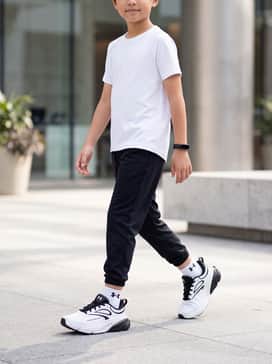 A sleek performance ensemble consisting of black moisture-wicking compression tights, a bright white technical running tee, and a slim fitness tracker for a professional runner aesthetic.