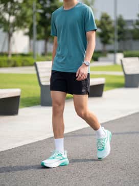 Ua Charged Rogue 6 – A performance-ready look featuring black moisture-wicking running shorts, a teal technical t-shirt that echoes the shoe's accents, and high-performance white crew socks.