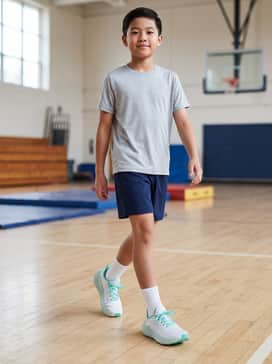 Ua Charged Turbulence 3 – School Gym Hero: Navy blue moisture-wicking athletic shorts paired with a light grey tech tee to highlight the crisp white mesh of the shoe.