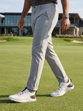 Ua Drive Pro Clone – A sleek grey quarter-zip technical pullover layered over a white moisture-wicking base layer, paired with khaki performance shorts for a warm day on the green.