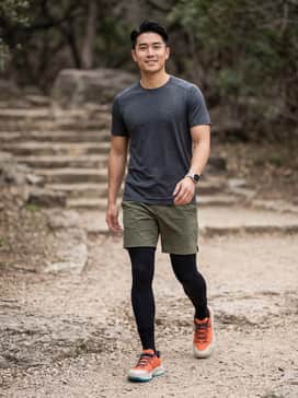 Ua Expanse Low – A performance-ready look featuring olive green ripstop hiking shorts, a moisture-wicking charcoal grey tech t-shirt, and black compression socks for a rugged trail aesthetic.
