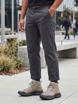 Ua Expanse Mid Waterproof – A rugged outdoor look combining heavy-weight tan utility shorts, a forest green flannel shirt worn over a white tee, and charcoal crew socks.