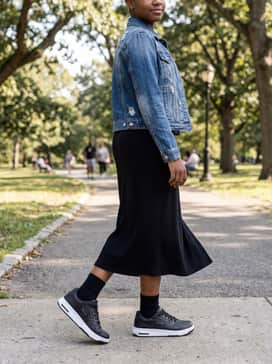 Ua Flex – A black ribbed midi dress layered under a distressed denim jacket to create a sporty yet feminine weekend ensemble perfect for city walking.