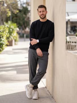 Style with charcoal tapered joggers and a clean black crewneck sweatshirt for a comfortable yet elevated athleisure outfit suitable for travel.