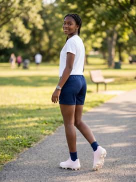 Team Travel: Style with navy blue athletic shorts and a moisture-wicking tech tee in a light lavender or white for a comfortable and stylish appearance during transit.