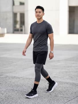 Ua Halo Runner Se – A performance-driven look featuring charcoal grey compression tights under black 5-inch running shorts, paired with a fitted moisture-wicking tech tee in a bright neon for visibility.