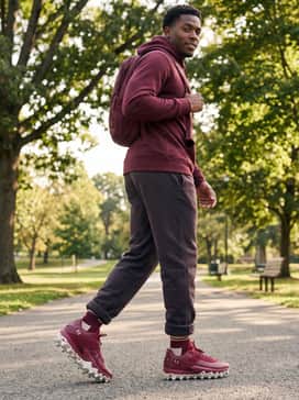 Ua Harper 10 Pro Tpu – Post-game sideline attire consisting of relaxed-fit fleece sweatpants, a coordinated maroon hoodie, and a technical gear backpack.