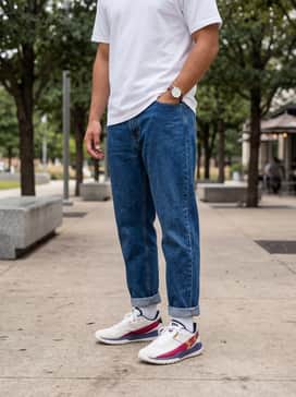 Ua Harper 10 Pro Turf Le Usa – A classic casual weekend ensemble consisting of slim-fit indigo denim jeans, a crisp white heavyweight cotton t-shirt, and a navy blue snapback cap to coordinate with the shoe's primary accents.