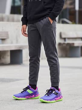 Match with charcoal grey joggers and a black graphic hoodie for a balanced yet sporty streetwear look.