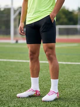 Black moisture-wicking compression shorts paired with a neon green tech tee for a high-contrast training look.