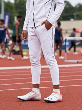 Ua Hovr Skyline Triple Jump – Coordinated team warm-up suit in a sleek white and black colorway with a zip-up jacket and tapered joggers to keep muscles warm between jump attempts.
