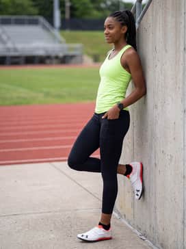 Technical training outfit consisting of a neon lime green racerback tank top paired with high-performance black compression shorts to mirror the shoe's accent colors.