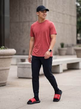 Ua Ignite Pro 8 – Black tapered joggers paired with a matching red moisture-wicking graphic tee and a black baseball cap.