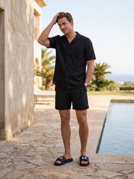 Ua Ignite Pro – Relaxed swim trunks in a bold solid color like royal blue, topped with a linen short-sleeve button-down for a sophisticated poolside vibe.