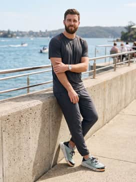 Ua Kilchis River – Charcoal grey athletic joggers with a technical t-shirt in a matching shade of burnt orange to highlight the shoe's accent colors.