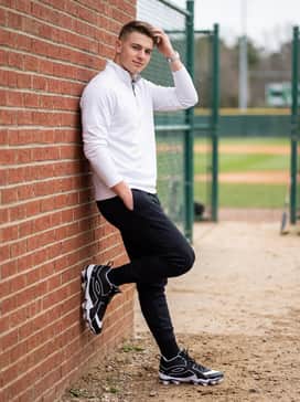 Ua Leadoff Icon Mid – A dynamic warmup look with black tech-fleece joggers tucked into white performance socks to highlight the mid-cut silhouette, paired with a white quarter-zip pullover.