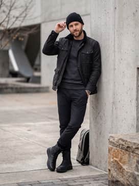 Ua Loadout Waterproof – Straight-leg raw indigo denim with a small cuff, paired with a thick flannel shirt and a black puffer jacket for a rugged and practical cold-weather outfit.