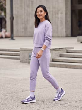 A coordinated lavender tracksuit with tapered joggers and a cropped sweatshirt to create a sleek, monochromatic sport-luxe aesthetic.
