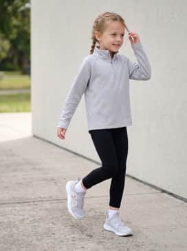A performance-ready kit for sports practice with black moisture-wicking leggings and a breathable light grey quarter-zip pullover.