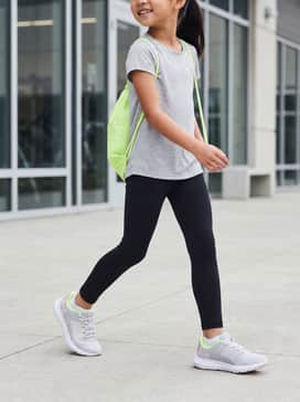 Black performance leggings and a neon lime racerback tank top for a coordinated gym-ready look.