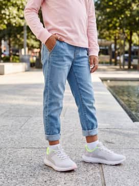 Cuffed denim joggers and a soft pink long-sleeve tee for a comfortable after-school outfit.