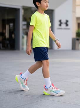A neon yellow moisture-wicking performance t-shirt paired with navy blue mesh athletic shorts and white crew socks for a high-energy gym look.