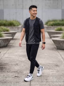 Ua Sonic 7 – A performance-ready look featuring black tapered tech joggers, a moisture-wicking charcoal grey t-shirt, and a lightweight running vest.