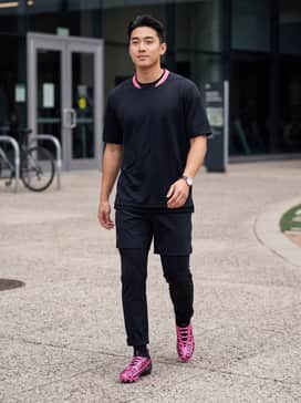 A matching black and pink team jersey paired with black compression tights and matching crew socks for a unified on-field look.