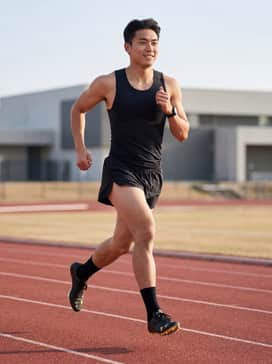 A professional team-branded compression singlet and lightweight aerodynamic split shorts in solid black.