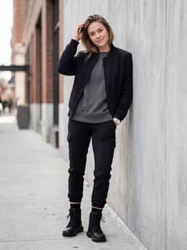 Ua Stellar – Slim-fit black denim jeans with a slight cuff to sit just above the boot, styled with an oversized graphite hoodie and a structured bomber jacket for an edgy urban aesthetic.