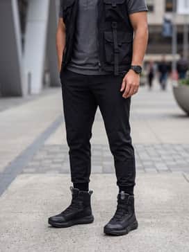 Classic straight-leg blue jeans, a grey thermal henley, and a rugged flannel overshirt for a functional outdoor-casual weekend outfit.