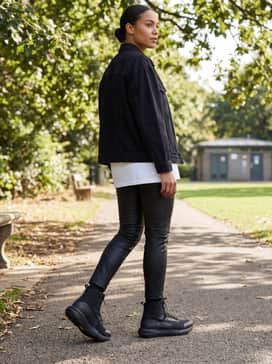 Ua Valsetz Tactical Womens Boots – Faux-leather skinny trousers paired with a longline white graphic tee and a black oversized denim jacket for a rugged, streetwear-inspired urban outfit.