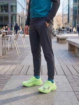 Ua Velociti Elite 3 – Dynamic Training: A teal-colored technical long-sleeve top matched with dark grey compression leggings and a reflective running vest for visibility during early morning miles.