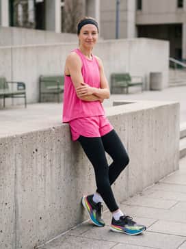 An athletic training look consisting of seven-inch black lined running shorts, a breathable hot pink performance tank top, and a moisture-wicking headband.