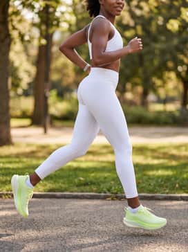 Ua Velociti Spd 5 – A monochromatic all-white athletic set consisting of a sports bra and high-waisted leggings to make the vibrant neon color of the shoes serve as a bold statement piece.