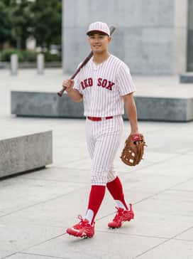 A full baseball uniform featuring white pinstripe pants, a matching red team jersey, and high-performance red stirrup socks for a professional look on the diamond.