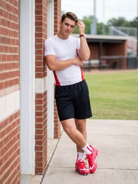 Black mesh athletic training shorts and a fitted white compression shirt with red side panels, ideal for intensive pre-game warm-ups.