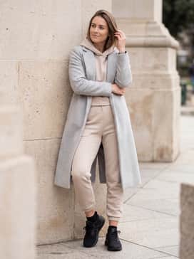 Polished Athleisure: Combine with matching beige-toned fleece joggers and a cropped hoodie, finishing the look with a long wool overcoat in light grey for a sophisticated 'off-duty' aesthetic.