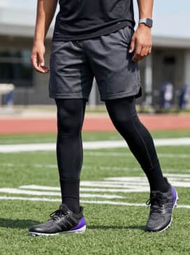 Ultraboost Football Cleats – Black performance compression leggings worn under charcoal mesh shorts and a moisture-wicking training tee for high-intensity drills.