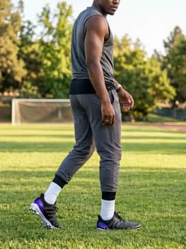 Ultraboost Football Cleats – Practice-ready attire including high-performance white crew socks and a sleeveless compression shirt to highlight the shoe's aggressive silhouette.