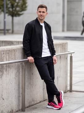 Ultrarun 5 Running Shoes – A modern streetwear outfit pairing slim-fit black denim jeans with a crisp white oversized t-shirt and a black bomber jacket, allowing the shoes to serve as the primary statement piece.
