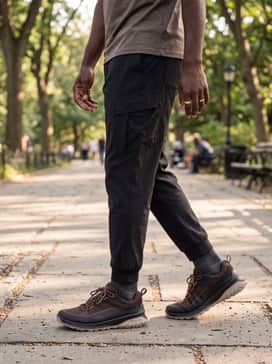 Ulttrn – Modern Utility: Wear with grey tapered joggers, a black windbreaker, and technical socks peeking out to emphasize the shoe's performance-oriented design.