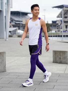 University Of Washington Adizero Evo Sl Shoes – High-performance purple compression tights paired with a white moisture-wicking racerback tank and a coordinating fitness tracker for a professional track look.