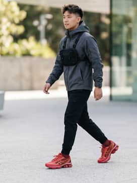 Us6s Gelkinetic Fluent – A full techwear ensemble with black tapered utility joggers, a charcoal grey oversized hoodie, and a tactical chest rig for an edgy, functional look.