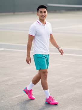 Vapor 12 Hypersmash – A performance-focused tennis ensemble featuring teal moisture-wicking shorts, a crisp white athletic polo with subtle pink trim, and white high-performance crew socks.
