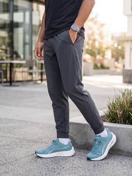 Combine with tapered charcoal grey joggers, a white technical fabric t-shirt, and a matching teal-accented lightweight windbreaker for a coordinated cool-weather training outfit.