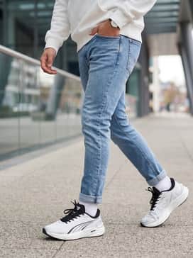 Style with slim-fit light wash denim jeans and an oversized white hoodie for a clean, contemporary streetwear aesthetic that pops.