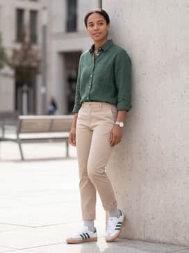 Beige slim-fit chinos paired with a tucked-in forest green linen button-down shirt to subtly highlight the shoe's secondary color.